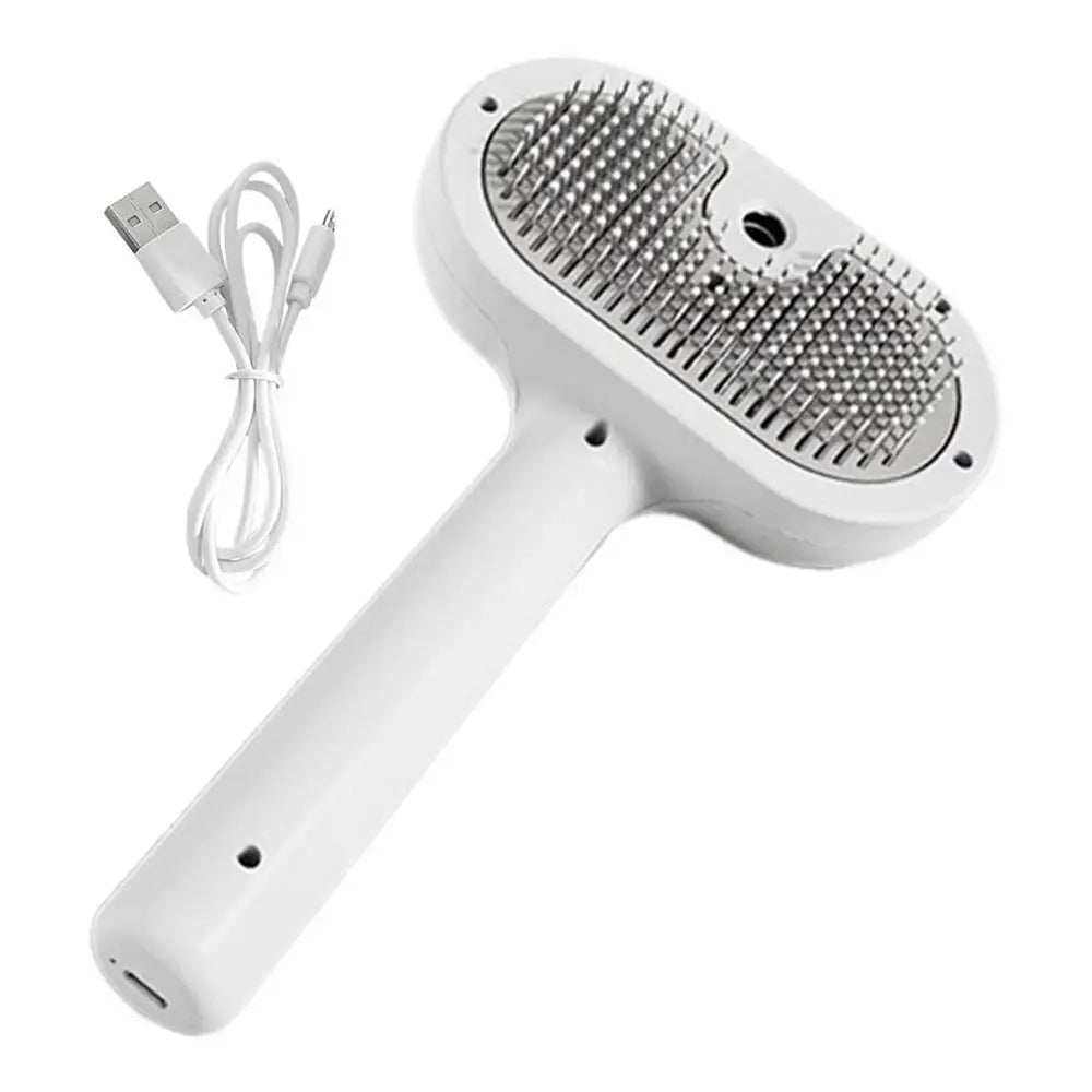 Brosse électrique blanche avec spray intégré pour toilettage et dépoilage des animaux, livrée avec câble de recharge USB.